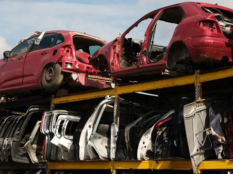 Dismantled car body shells and doors in a vehicle yard