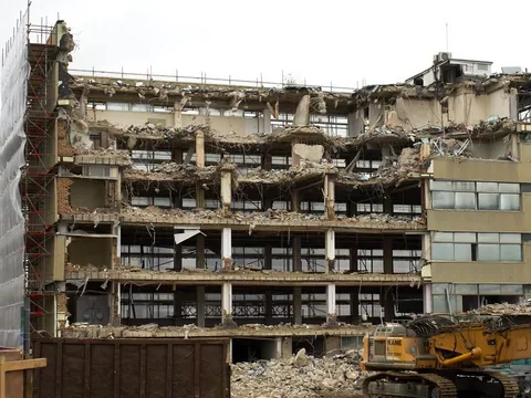 Demolition site with exposed concrete structure and rubble