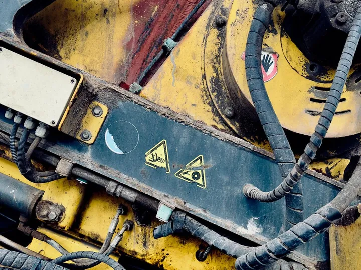 Close view of hoses and hydraulic machinery parts