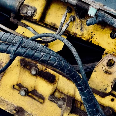 Close view of hoses and hydraulic machinery parts